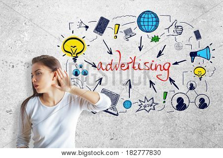 Young woman not able able to hear on concrete background with colorful sketch. Advertising concept