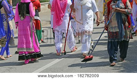Sikh Women While Scavenging The Street With A Broom During A Fes