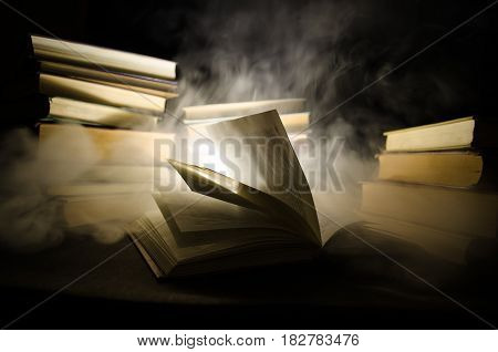 Many Old Books In A Stack. Knoledge Concept. Books On A Dark Background With Smoke Elements. Bewitch