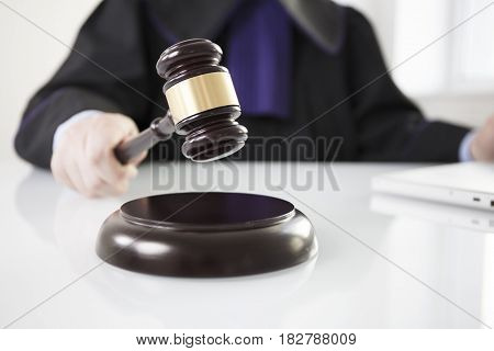 Mallet in the hand of the judge. Law concept.