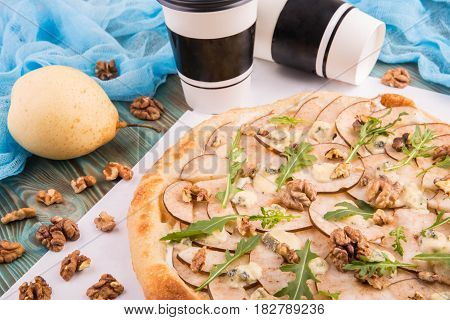 Pizza with a pear and crude Dorblu with walnut and lemon oil
