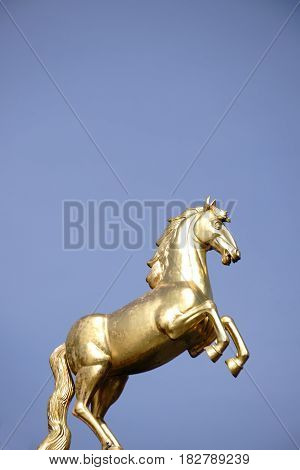 MAINZ, GERMANY - MARCH 24: The golden Ross sculpture on the roof of the main museum Mainz in the sunlight on March 24, 2017 in Mainz.