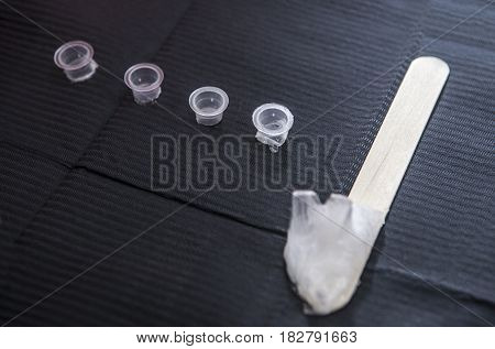 Small caps for ink and depressor full of vaseline. First tage of tattoo process