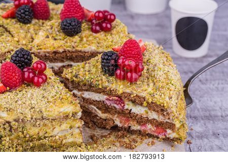 Pistachio cake with fresh berries, raspberry and red currant