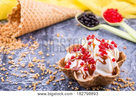 An ice cream basket with caramel jam, sprinkled jelly balls