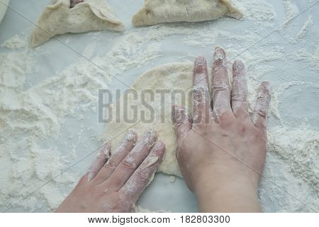 Preparing dough. Baking peremech concept. Flour, dough and meat cooking ingredients. Hands top view of cooking.