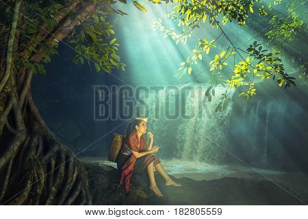 Asian woman at the waterfall north of Thailand