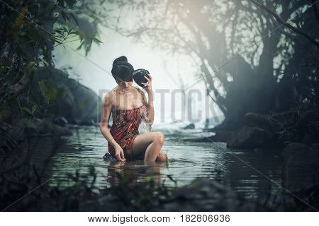 Asian sexy woman bathing in cascade Thailand