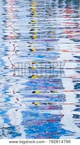 Refelected abstract colors in water below Port of Tauranga container terminal