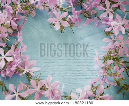 flowers in form of heart on wooden background