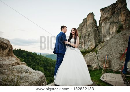Lovely Wedding Couple Against Rocks Of Fortess Tustan At Carpathian Mountains.