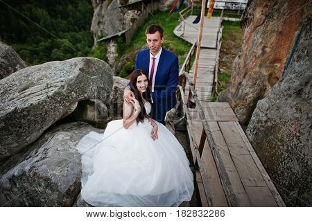 Lovely Wedding Couple Against Rocks Of Fortess Tustan At Carpathian Mountains.