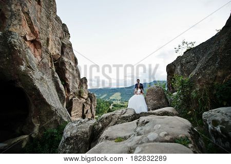 Lovely Wedding Couple Against Rocks Of Fortess Tustan At Carpathian Mountains.