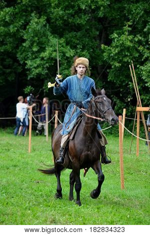 TERVETE LATVIA - AUGUST 13 2011: Historical Zemgalu days. Unknown rider on horseback in ancient clothing with ancient weapons.