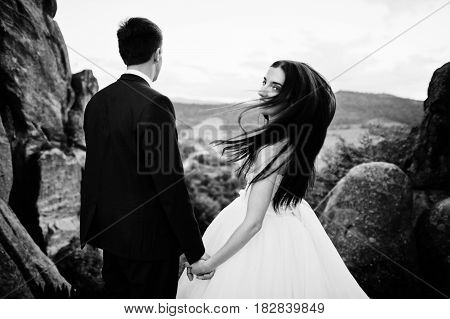 Lovely Wedding Couple Against Rocks Of Fortess Tustan At Carpathian Mountains.