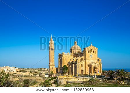 Gozo Malta - The Basilica of the National Shrine of the Ta' Pinu early at the morning with clear blue sky on a summer day