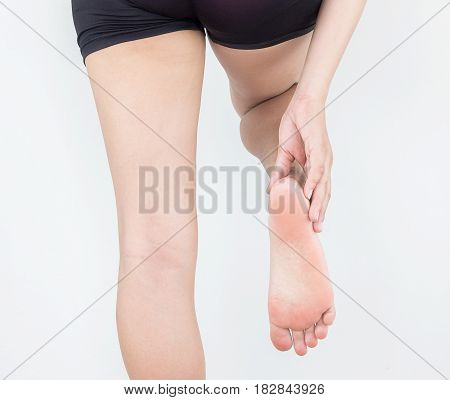 Heel pain in women Woman massaging her foot.