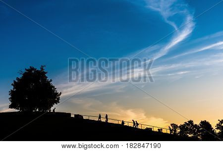 silhouette image of group of people in sunset time on stariway for background.