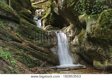 Waterfall on stream in the Carpathian mountains, rocky streambed