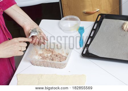 Stages Of Preparation Of Meat Glomeruli. A Woman Forms Minced Meat. Next To The Table Is A Dough And