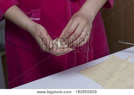 Preparation Of Meat Glomeruli. Stuffed Turkey, Wrapped In Strips Of Puff Pastry. A Woman Winds A Str
