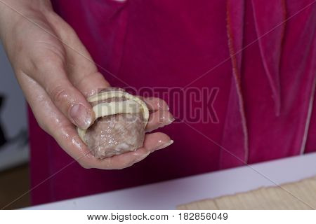 Preparation Of Meat Glomeruli. Stuffed Turkey, Wrapped In Strips Of Puff Pastry. A Woman Is Holding