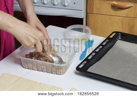 Stages Of Preparation Of Meat Glomeruli. A Woman Stirs Stuffing. Next To The Table Is A Dough And To