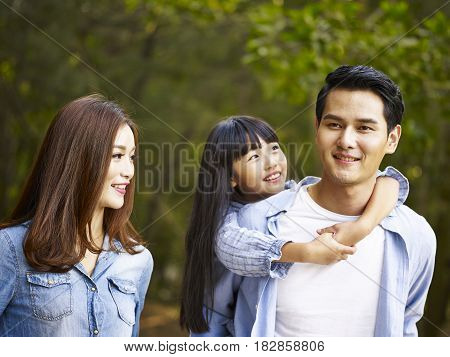 young asian family taking a walk enjoying nature.