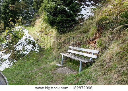 Peaceful seating in Gimmelwald with Snow and green yellow grass in Switzerland Autumn