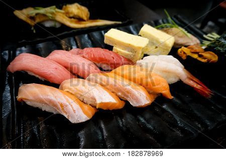 Close up of japanese raw fish delicious sushi in black plate