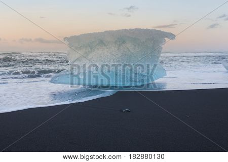 Ice breaking from iceberge on black sand beach Iceland winter season landscape background