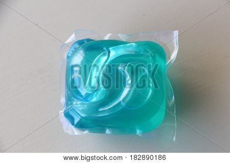 Soluble dose of liquid detergent on a table