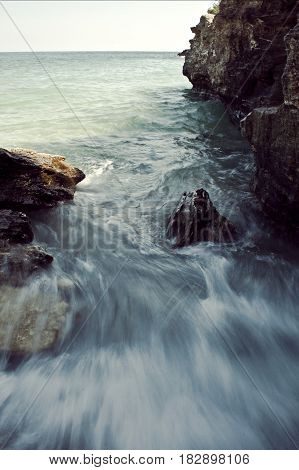 The sound of waves when crashing on rocks.
