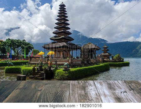 vintage wood terrace with view of Pura Ulun Danu Batur is hindu temple at Bratan lake in Bali Indonesia soft focus selective focus copy space.