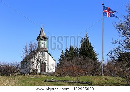 Small old chapel in Thingvellir and a Iceland Flag