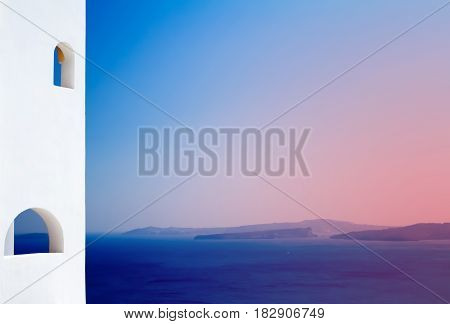 The white house on a rock.The sea and the volcano. Of the Mediterranean sea. Greece.