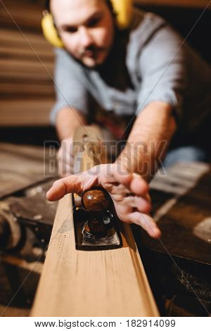 Carpenter in the workshop at work working with wood