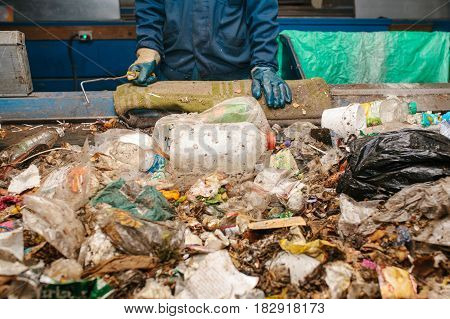 The worker sorts the waste received by a modern plant for sorting and recycling waste. Waste processing plant. Technological process. Recycling and storage of waste for further disposal.