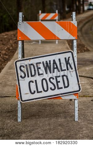 Sidewalk Closed Sign Askew on Stand Full Frame Vertical