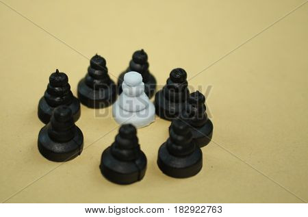 Discrimination harassment middle class defense extremism concept. Chess pawn pieces photo
