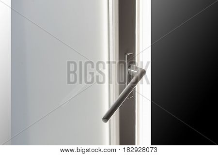 Detail of handle on wooden window on background