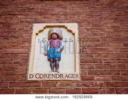 An enblem against a brick background in Amsterdam