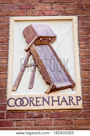 An enblem against a brick background in Amsterdam