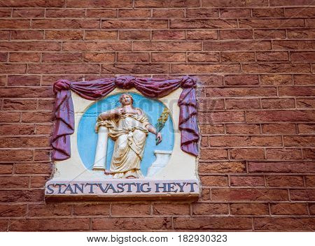 An enblem against a brick background in Amsterdam