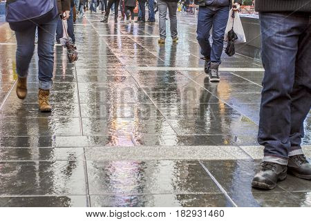 Walking in New York City after the rain with reflections on the concrete