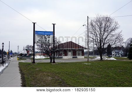 KALKASKA, MICHIGAN / UNITED STATES - NOVEMBER 27, 2016: A sign outside of the Kalkaska Historical Museum advertises an upcoming shopping event in downtown Kalkaska.