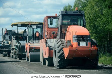 Tractor, roller , truck on the road repair site. Road construction equipment. Road repair concept.