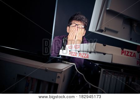 nerd sitting in front of his computers all night long