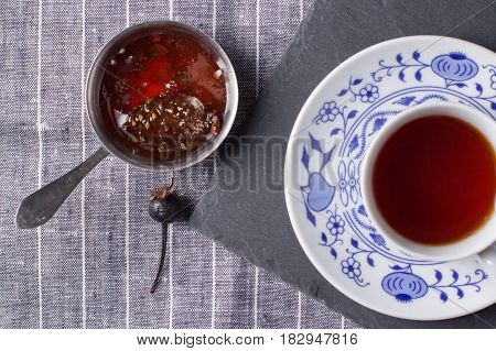 Cup for tea located on a black board top view