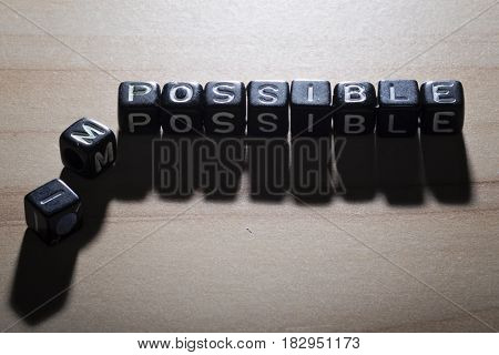 POSSIBLE and IMPOSSIBLE, by black alphabet beads